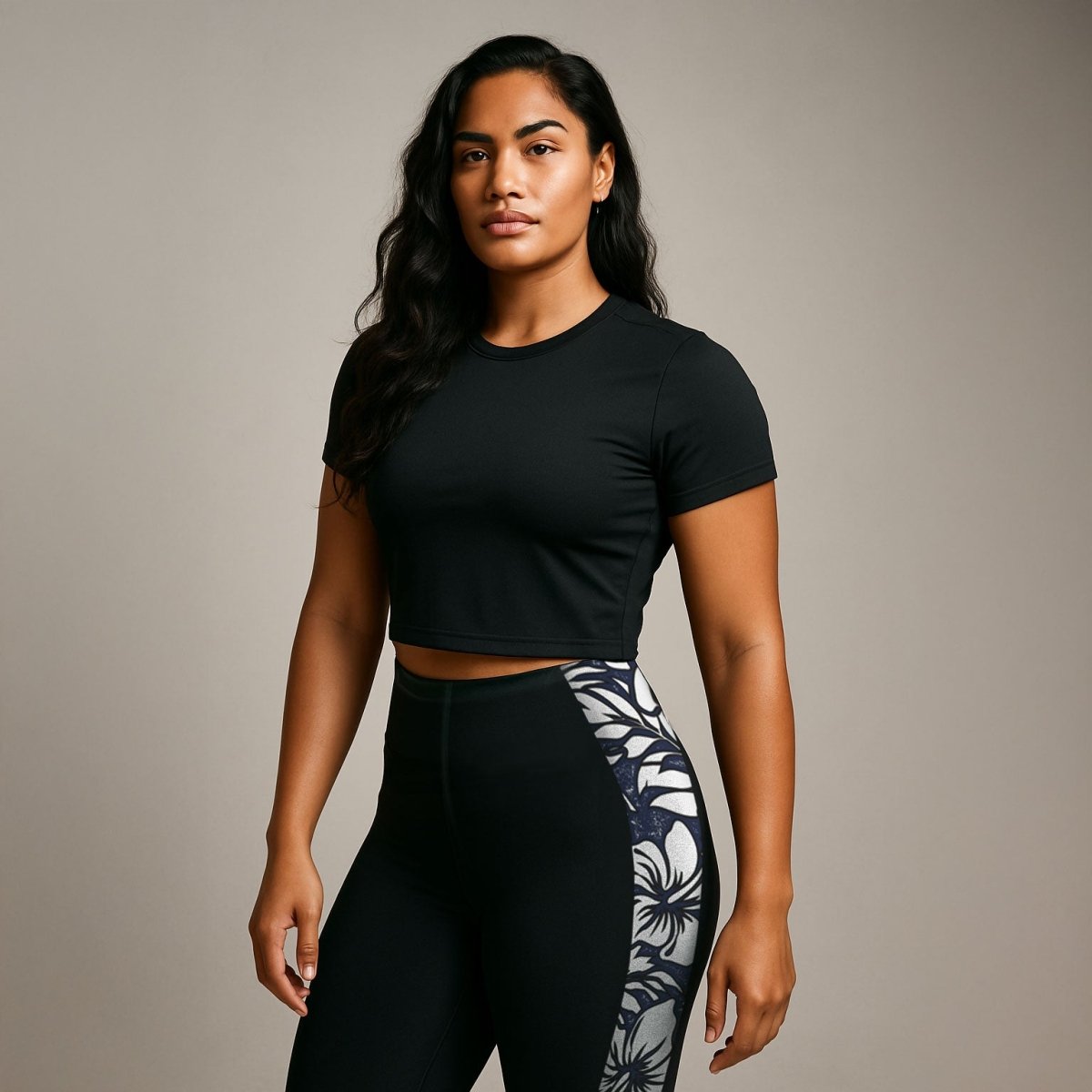 Black FYBY IslandFlex Mid-Rise Leggings in Falefa Breeze design, shown on a model, highlighting the fitted waist and comfortable stretch
