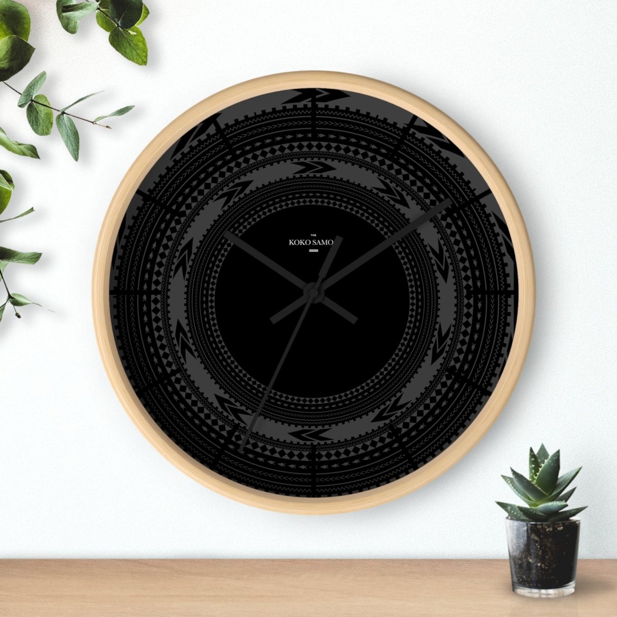 Black 10-inch wall clock with Pe'a design, suitable for AU, NZ, and US homes, styled as modern home decor.