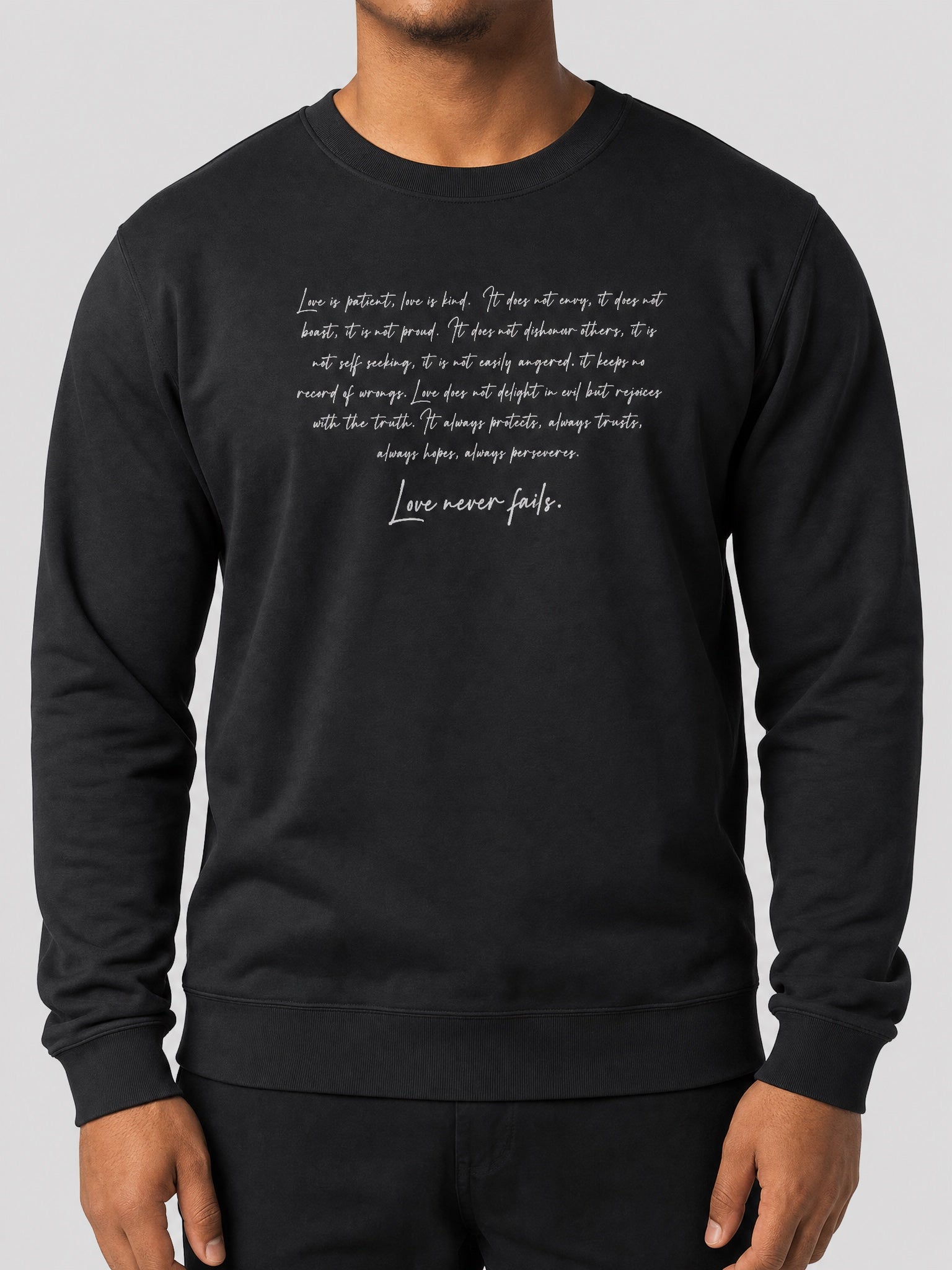Champion  Unisex Sweatshirt - Love Never Fails on a light grey studio background