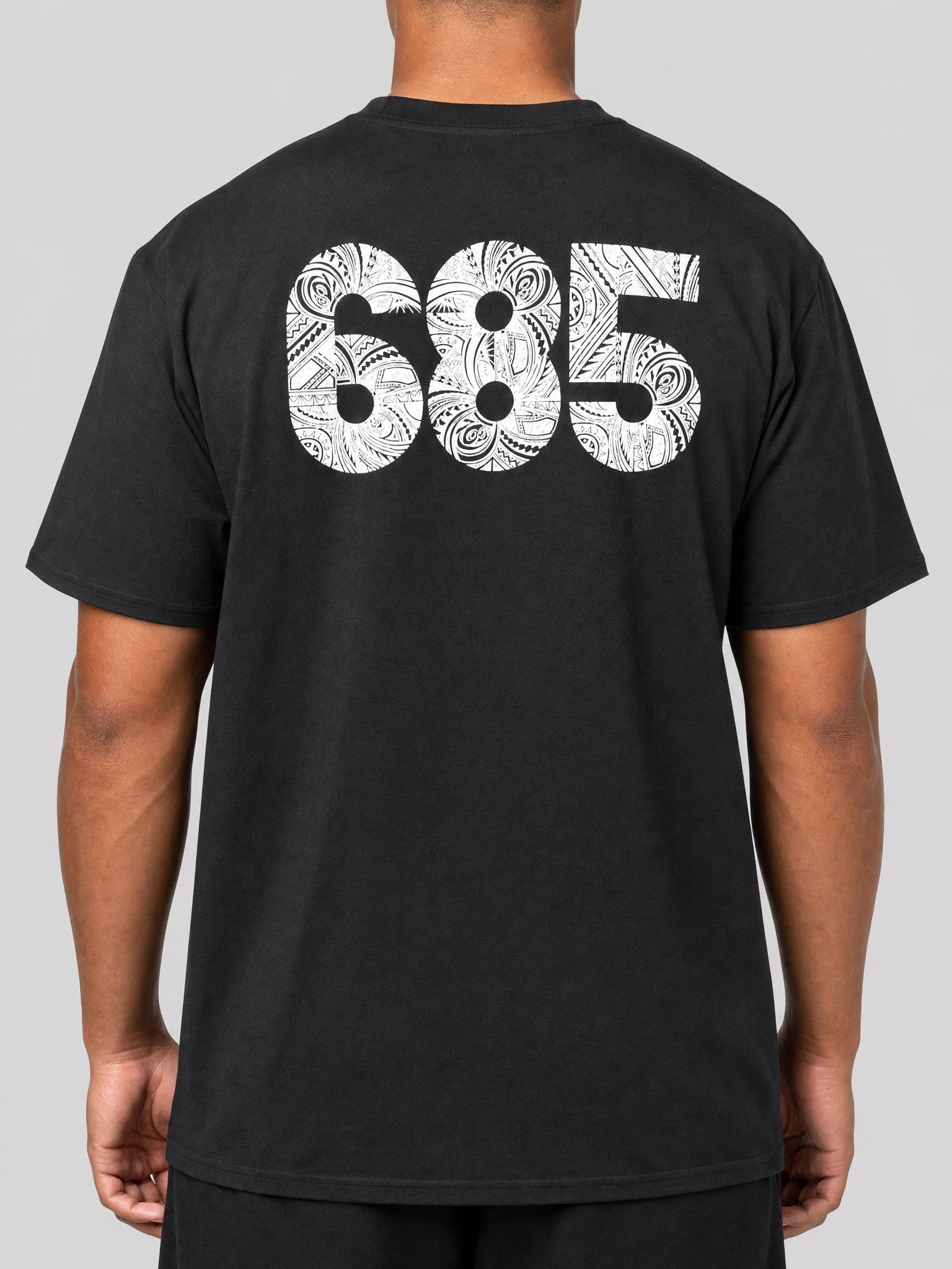Unisex Tee - 685 on a light grey studio background