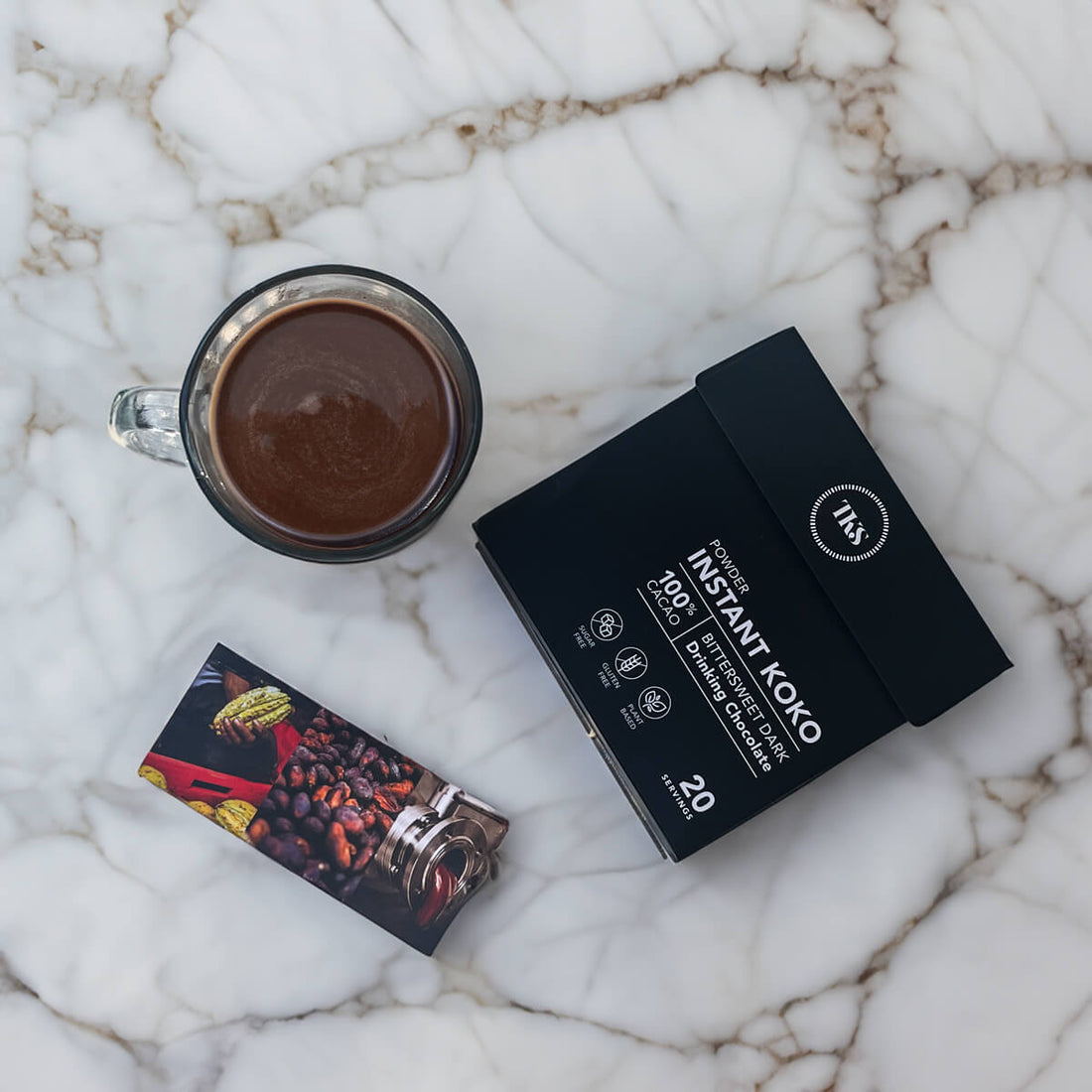 Instant Koko Samoa drinking chocolate by THE KOKO SAMOA, creamy cocoa powder in a jar, ideal for hot chocolate beverages.