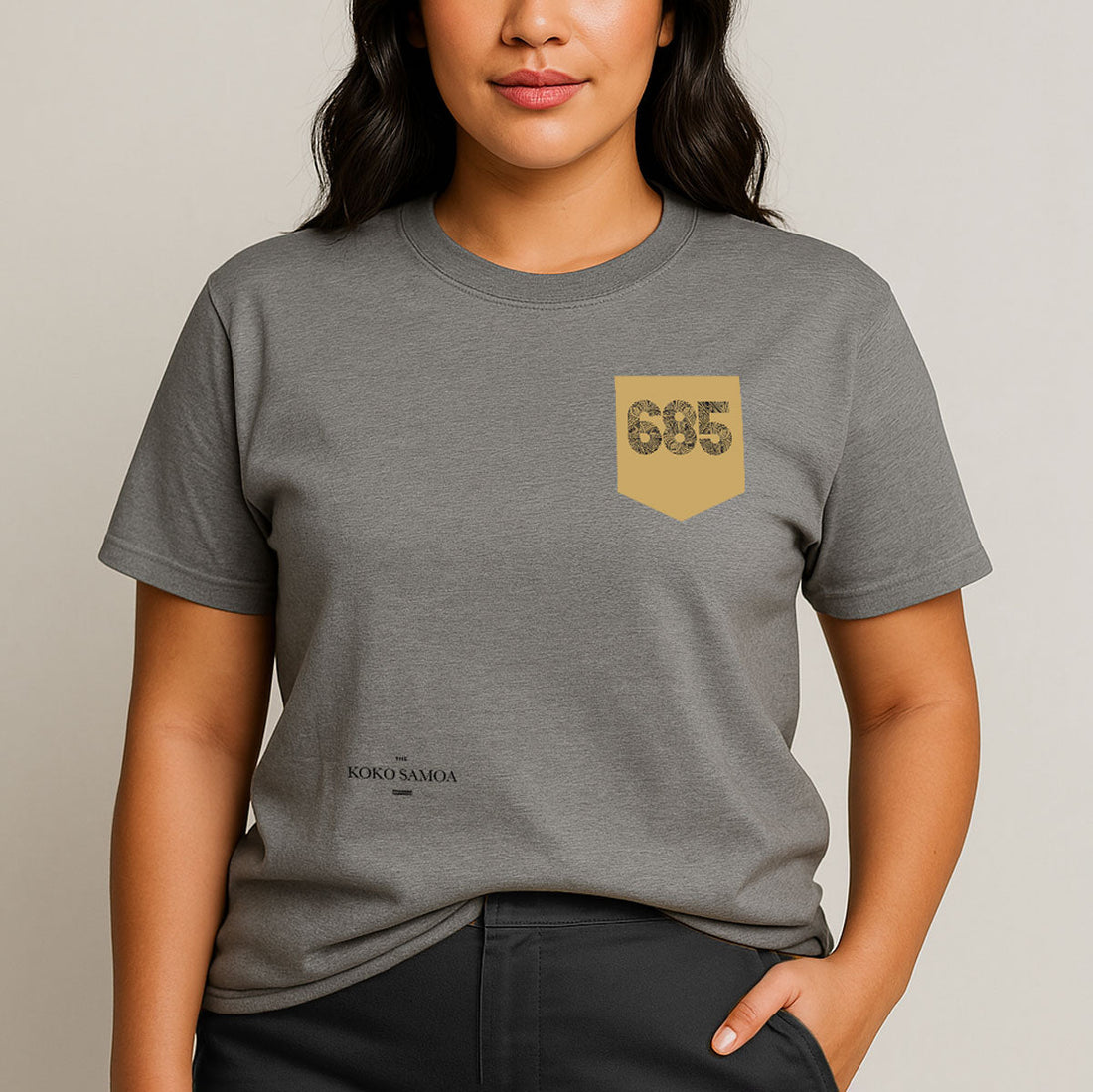 Unisex soft tee featuring '685 Pocket' print in army color, shown in XS size on a model.