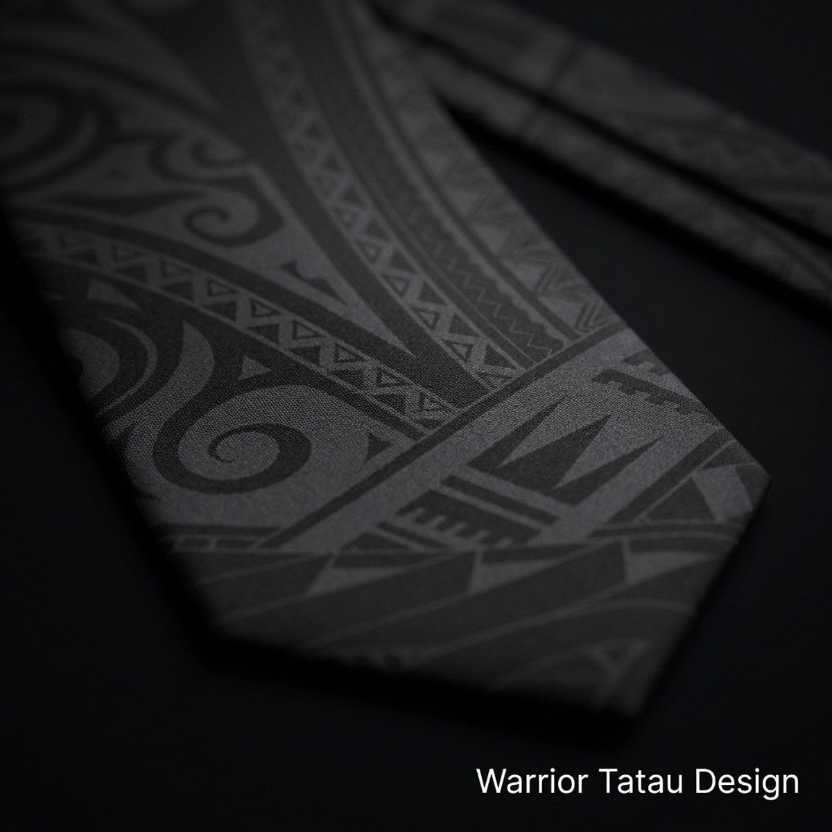 Close-up of the Warrior tatau design on black matte necktie fabric